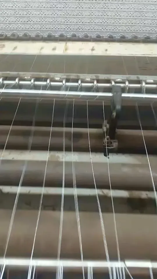 Shuttle embroidery machine producing guipure lace at Decent Lace Trader, Faisalabad