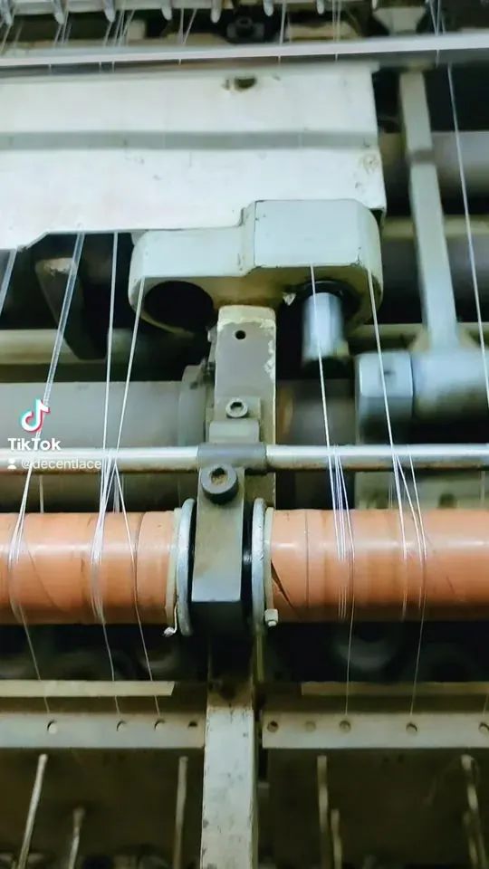 Shuttle embroidery machine producing guipure lace at Decent Lace Trader, Faisalabad